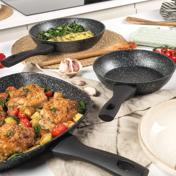 Square non-stick grill pan on induction hob with chicken and sliced peppers