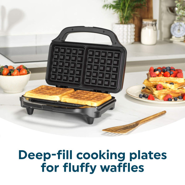 Open black waffle maker with two waffles and text: Deep-fill cooking plates for fluffy waffles