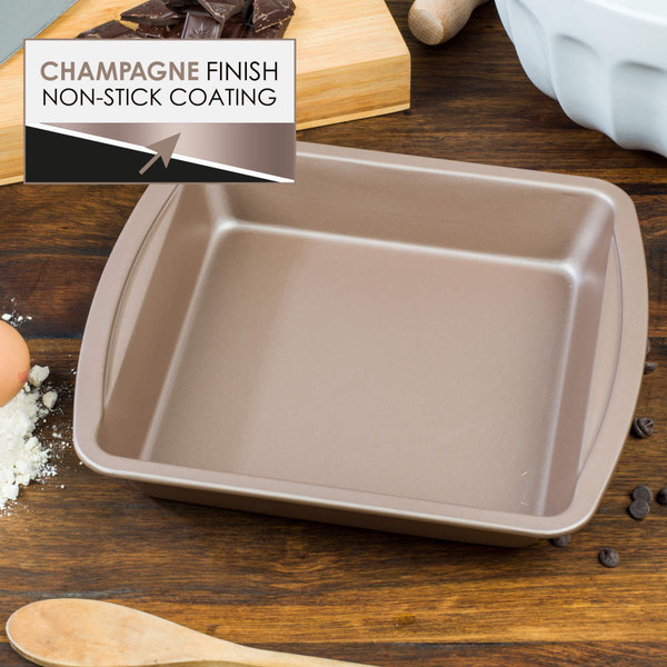Champagne colour non-stick square baking tin on wooden surface, shown from above.