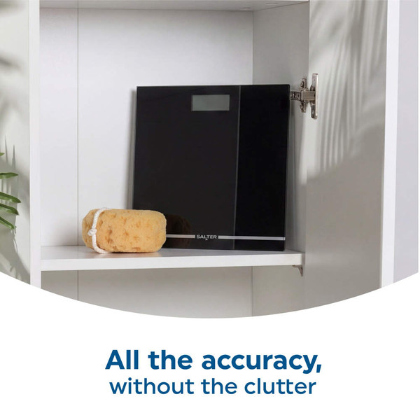 Black digital bathroom scale stored on a white shelf