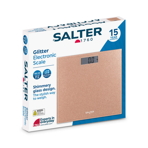 Rose gold glitter glass electronic scale in retail packaging, showing LCD display.