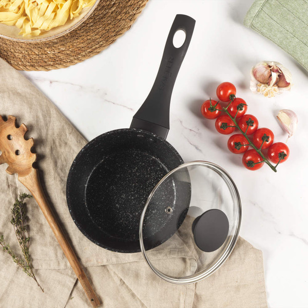 Set of Salter black-handled saucepans and frying pan in use, view from above