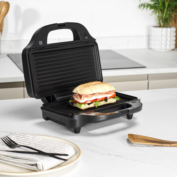 Electric omelette maker with two cooked vegetable omelettes in kitchen setting