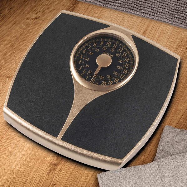 Mechanical bathroom scale with black and gold finish, 136kg maximum capacity.