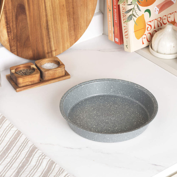 Round grey speckled baking tin on kitchen worktop
