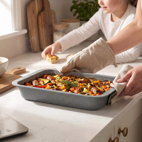 Grey roasting tin with cooked casserole being served in a home kitchen setting