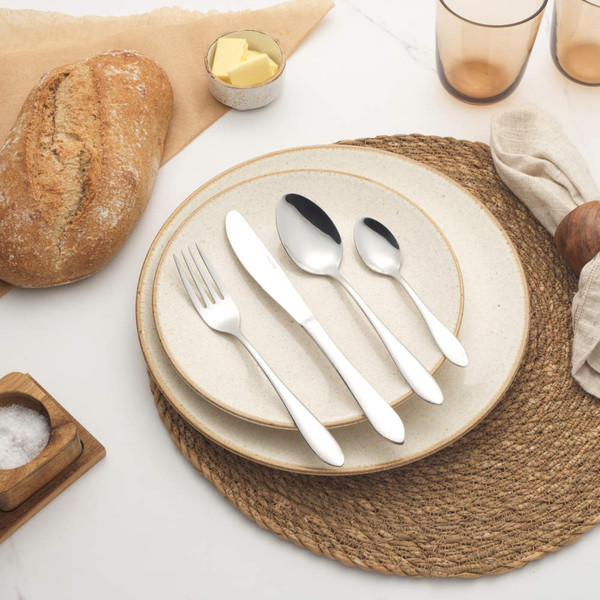 Set of four silver stainless steel cutlery pieces: knife, fork, dessert spoon, teaspoon.