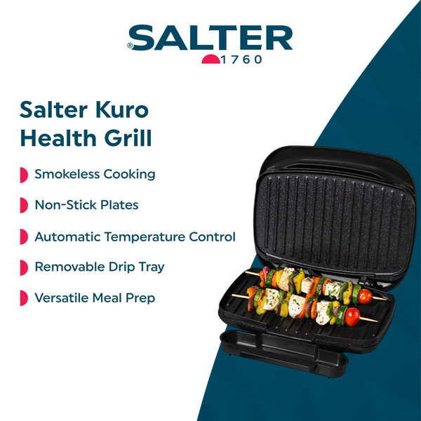 Electric grill open on kitchen counter with hand placing chicken kebab inside.