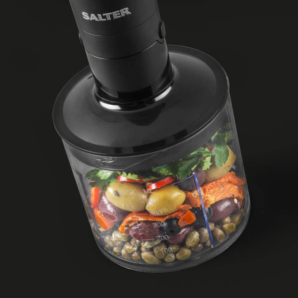 Salter black food chopper with clear bowl showing mixed Mediterranean ingredients