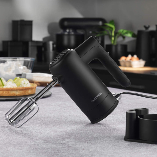Black electric hand mixer with beaters on kitchen counter, Salter brand visible.