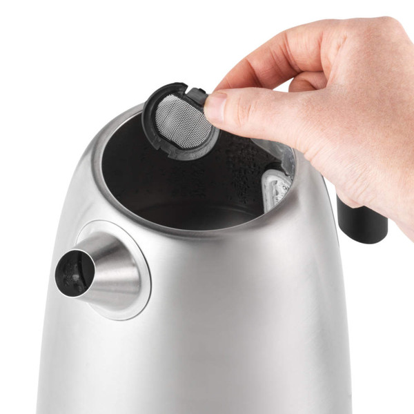 Hand removing limescale filter from stainless steel electric kettle spout
