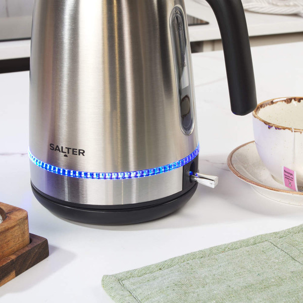 Stainless steel electric kettle with blue LED light, Salter brand, kitchen setting.