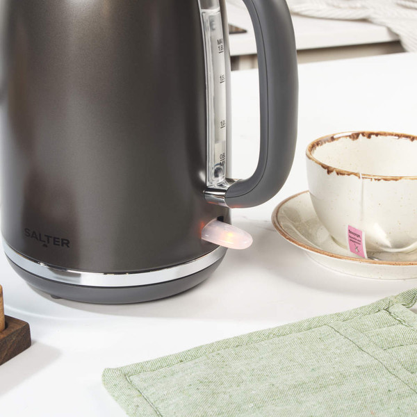 Gunmetal kettle, toaster, and microwave set on kitchen counter