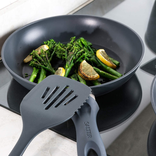 Non-stick frying pan with Salter spatula, cooking broccolini and lemon slices on hob