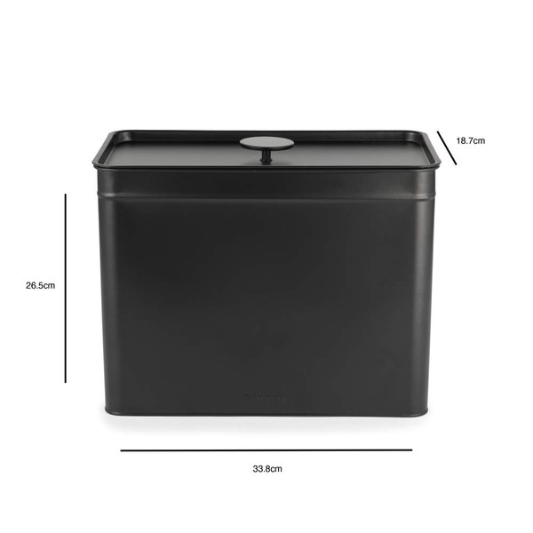 Set of black metal kitchen storage tins, including one open with tea bags, on countertop