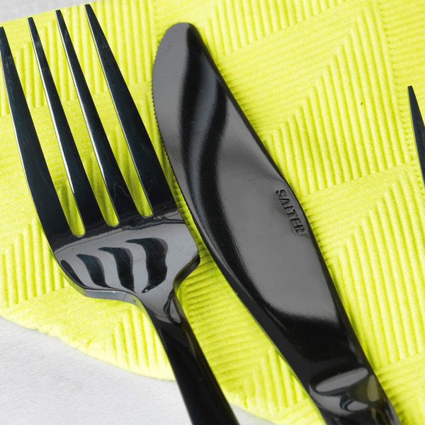 Black fork and knife on yellow napkin, close-up, Salter branding visible