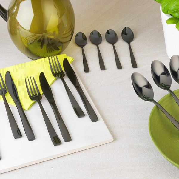 Black cutlery set with forks, knives and spoons on a tabletop, shown in a group.