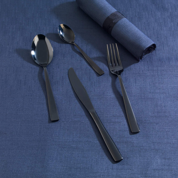 Set of four matte black cutlery pieces, including knife, fork, spoon, and teaspoon on blue cloth.