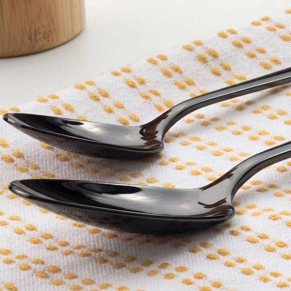 Black knife and fork close-up on white cloth