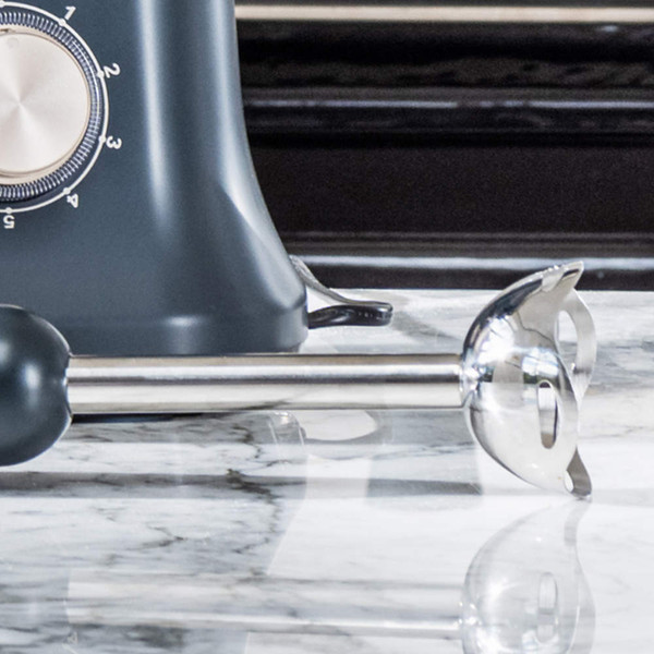 Grey stick blender and mixer base on kitchen worktop