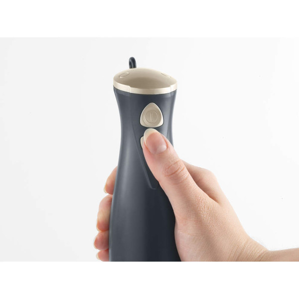 Hand holding grey electric can opener showing power button