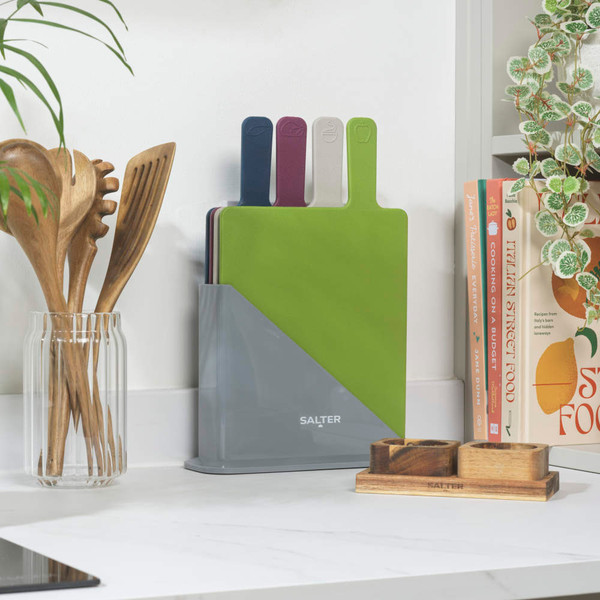 Set of four colour-coded chopping boards in grey Salter stand, kitchen worktop.