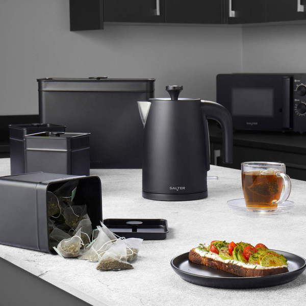 Black Salter electric kettle on kitchen counter with tea caddy, cup of tea and toast