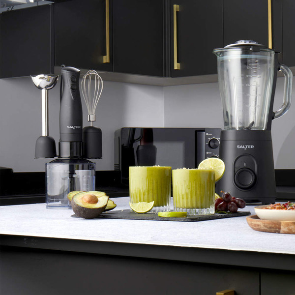 Salter black hand blender set and jug blender on a kitchen counter with green smoothies