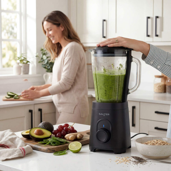 Salter black blender blending green smoothie, with fresh fruit and oats on kitchen counter