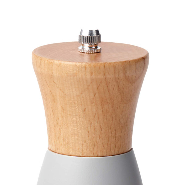 Light wood and silver pepper mill, close-up of adjustable top.
