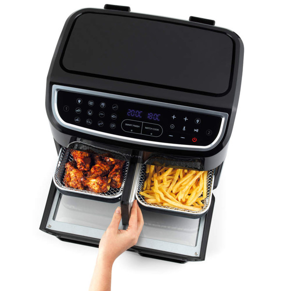 Black dual basket air fryer with digital display, shown with chips and chicken wings inside.
