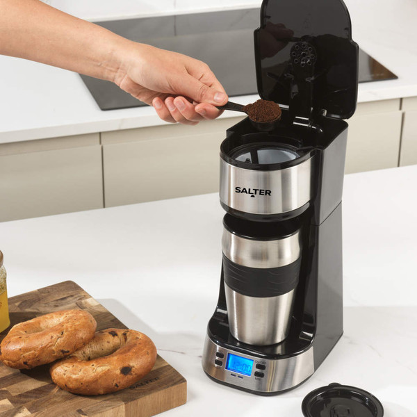 Silver and black single-serve coffee maker with closed lid, shown from above