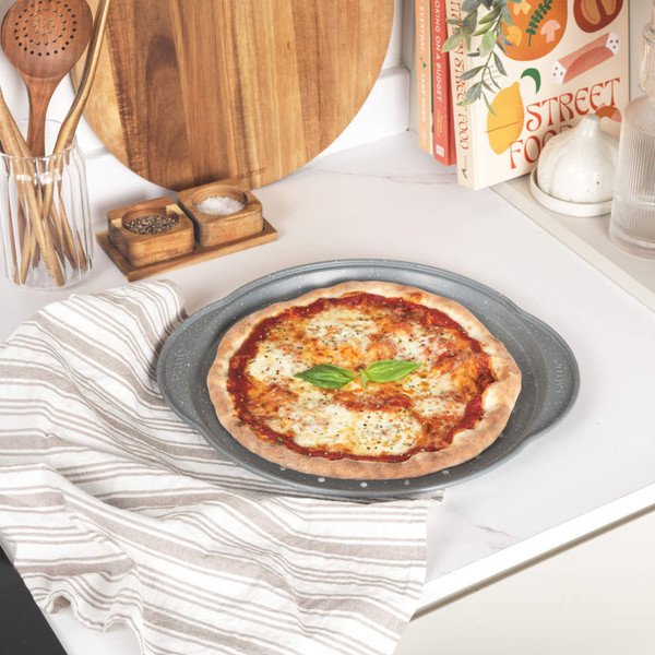 Grey non-stick perforated pizza tray shown flat, ideal for baking crispier pizza bases
