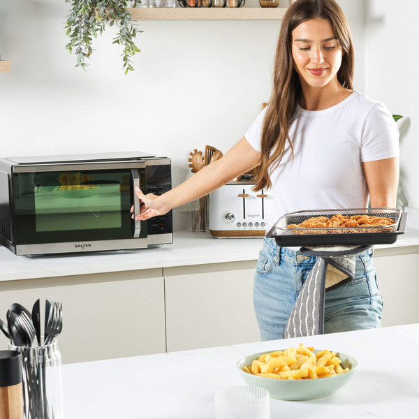 Microwave accessory set with mesh basket, black baking tray, and glass turntable.