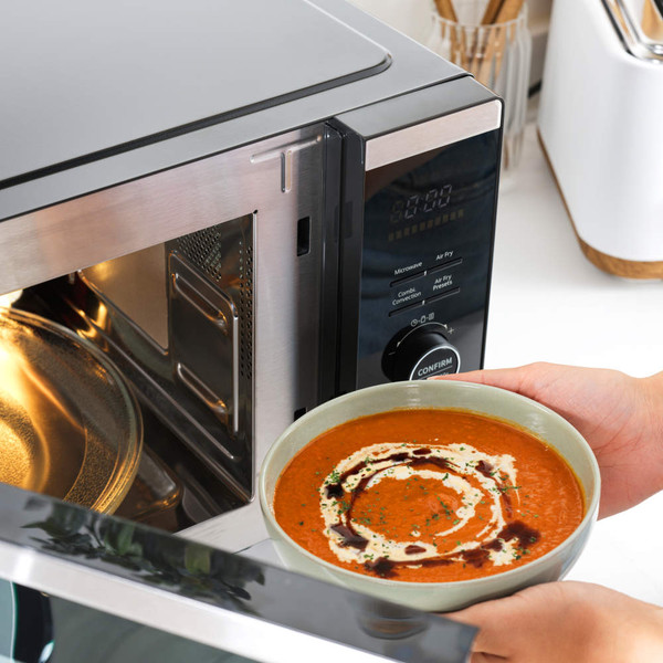 Black and silver Salter microwave on kitchen counter, dimensions 45 D x 52.3 W x 30 H cm shown