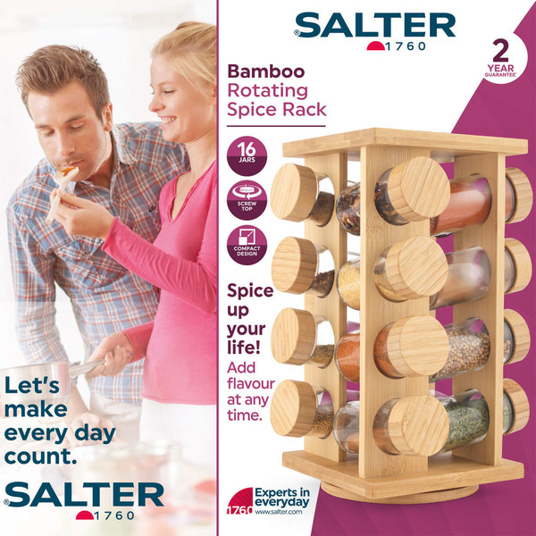 Rotating bamboo spice rack with glass jars on kitchen worktop, hand picking jar