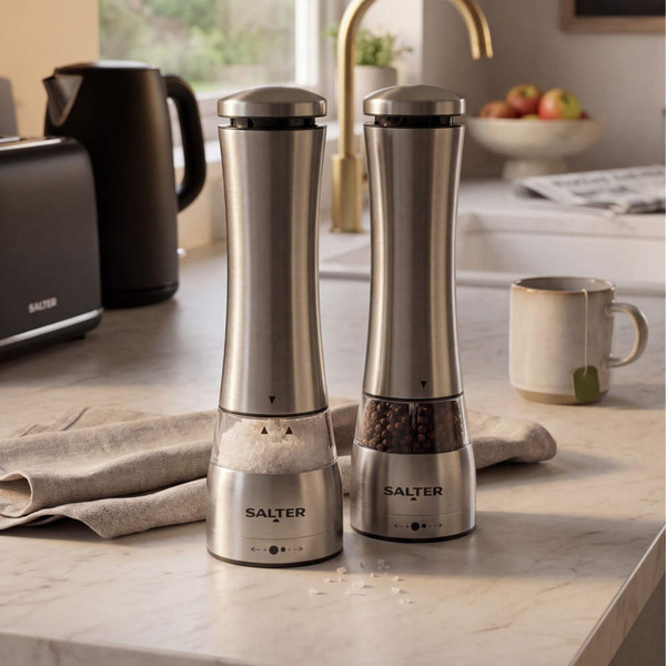 Salter electric salt grinder in use next to pepper grinder on kitchen counter