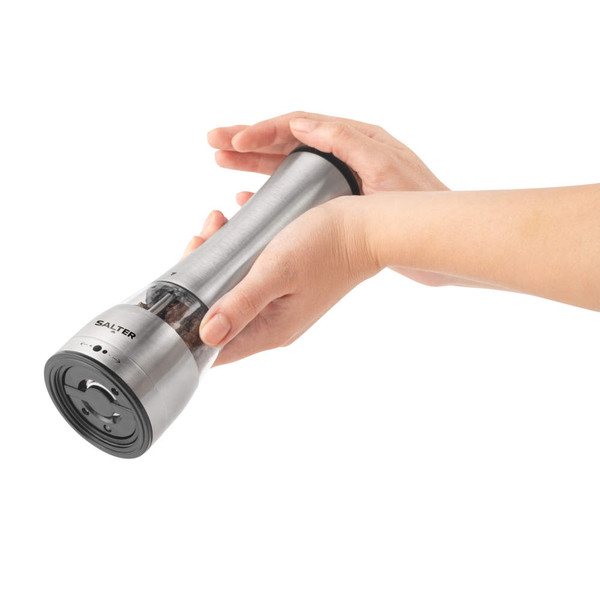 Silver electric salt or pepper grinder held in hand, showing grinding action