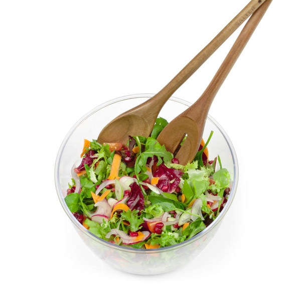 Glass bowl of mixed salad with wooden servers