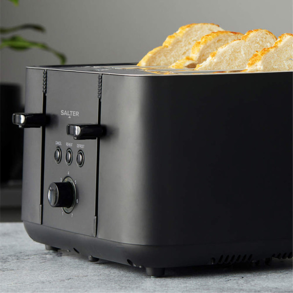 Black 4-slice toaster with slices of toasted bread, angled for feature display