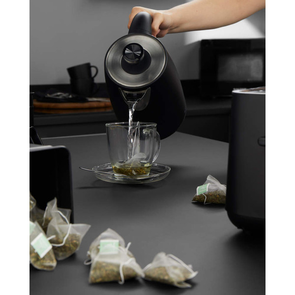 Black Salter kettle and toaster set on kitchen counter with tea canisters and glass cup