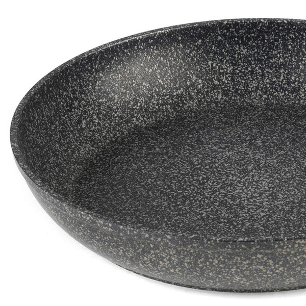 Large round speckled black non-stick frying pan, close-up interior view