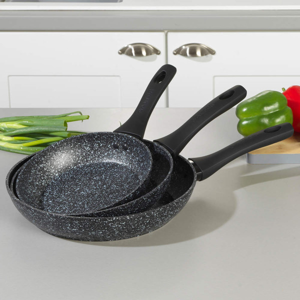 Set of three non-stick speckled frying pans with black handles on kitchen worktop