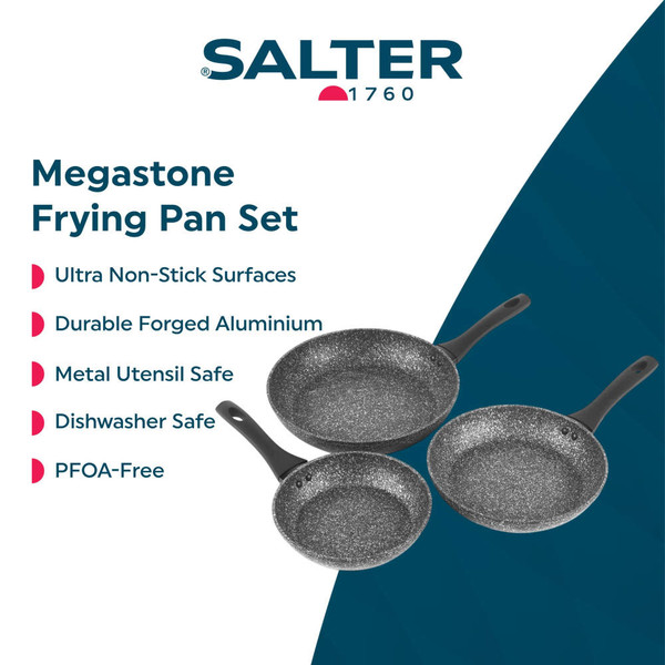 Set of speckled non-stick frying pans with cooked fish and peppers, kitchen background