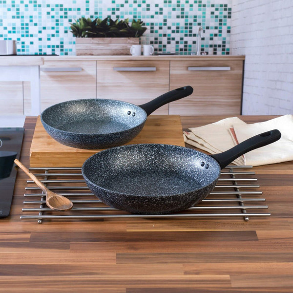 Set of two grey speckled frying pans with black handles in modern kitchen