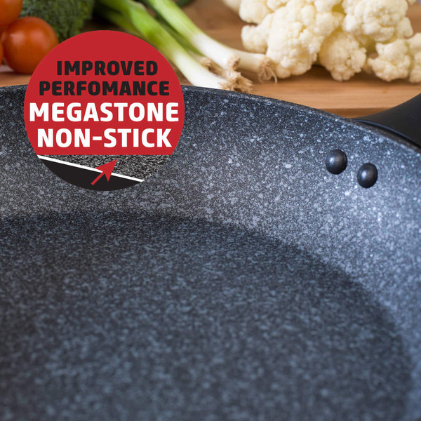 Close-up of Megastone non-stick frying pan with vegetables in background, promotional badge highlights improved performance