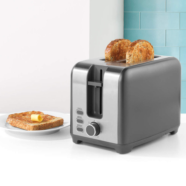 Stainless steel 2-slice toaster with toasted bread, shown next to plate with buttered toast.