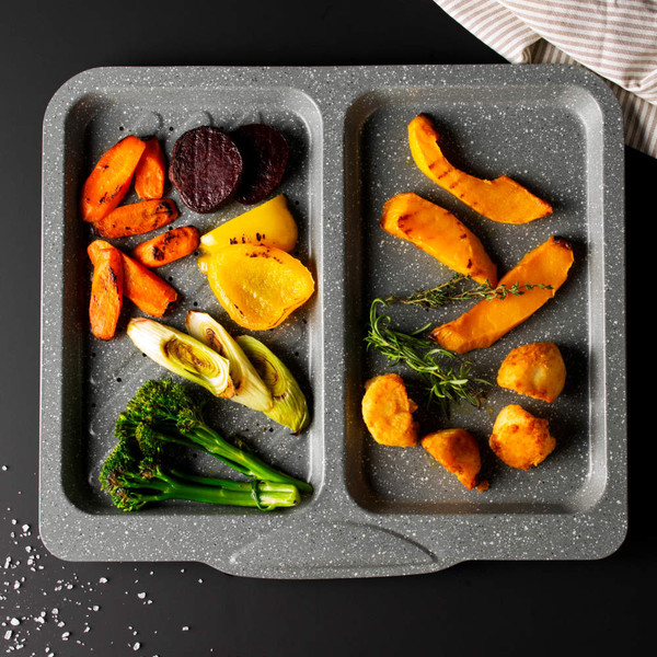 Grey double oven tray with assorted roasted vegetables, shown from above for product detail