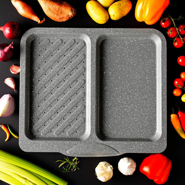 Large grey non-stick 2-section oven tray with speckled finish, shown with fresh vegetables