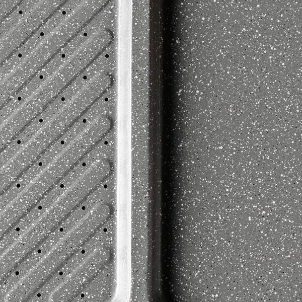 Grey speckled enamel oven tray close-up showing perforated and solid sections